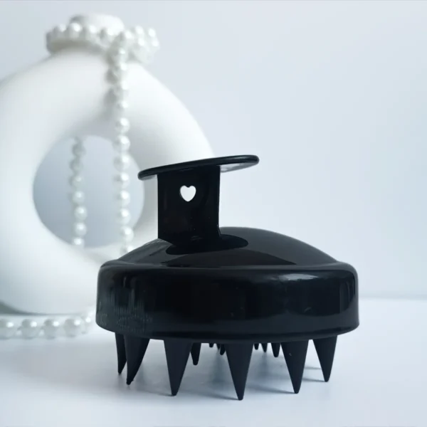 Masażer do skóry głowy w kolorze czarnym.