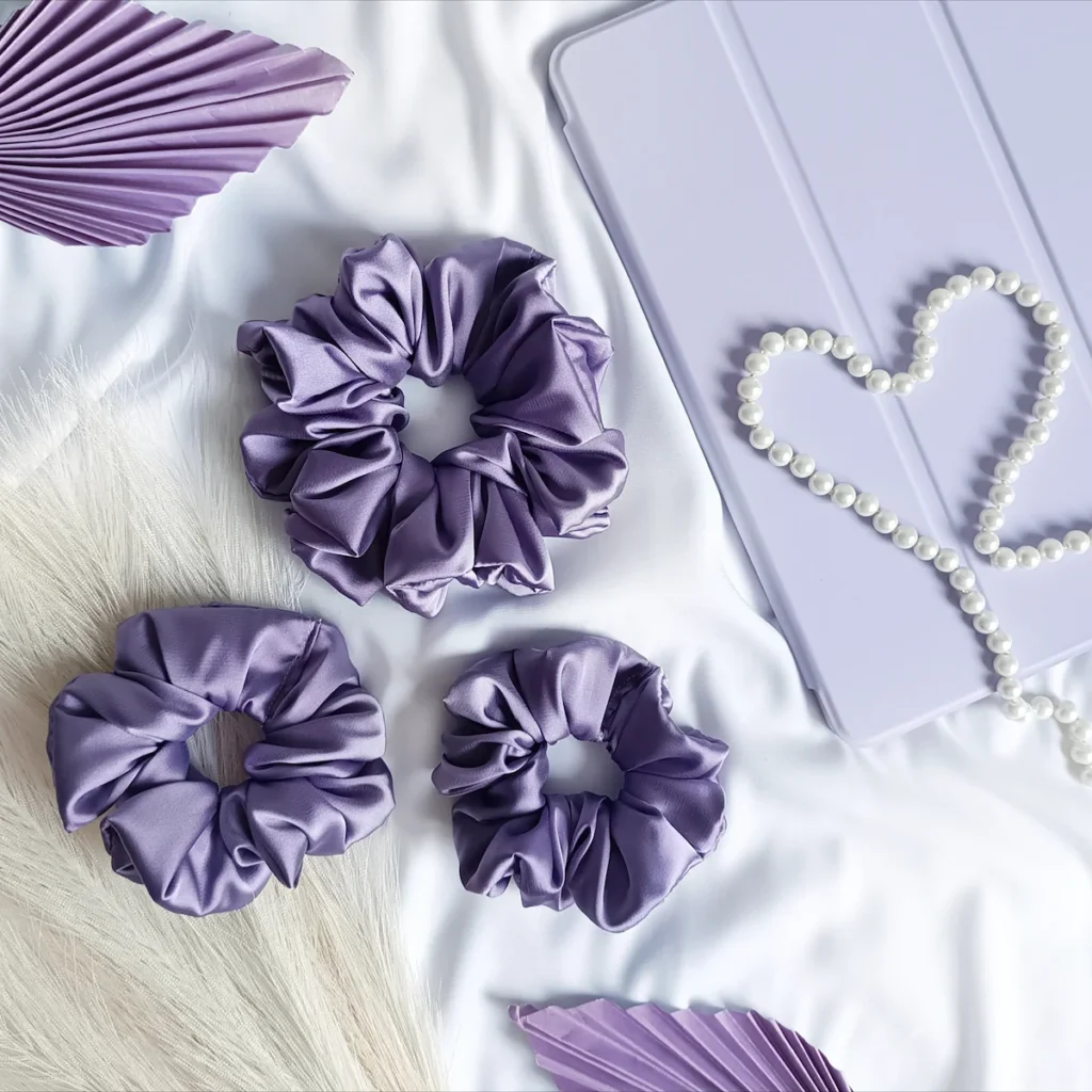 Scrunchie z satyny jedwabnej w kolorze lawendowym.
